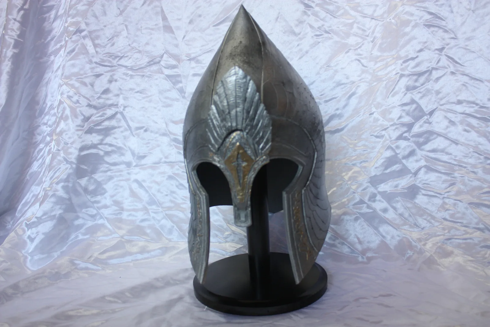Pointed Gondorian helmet on a black stand