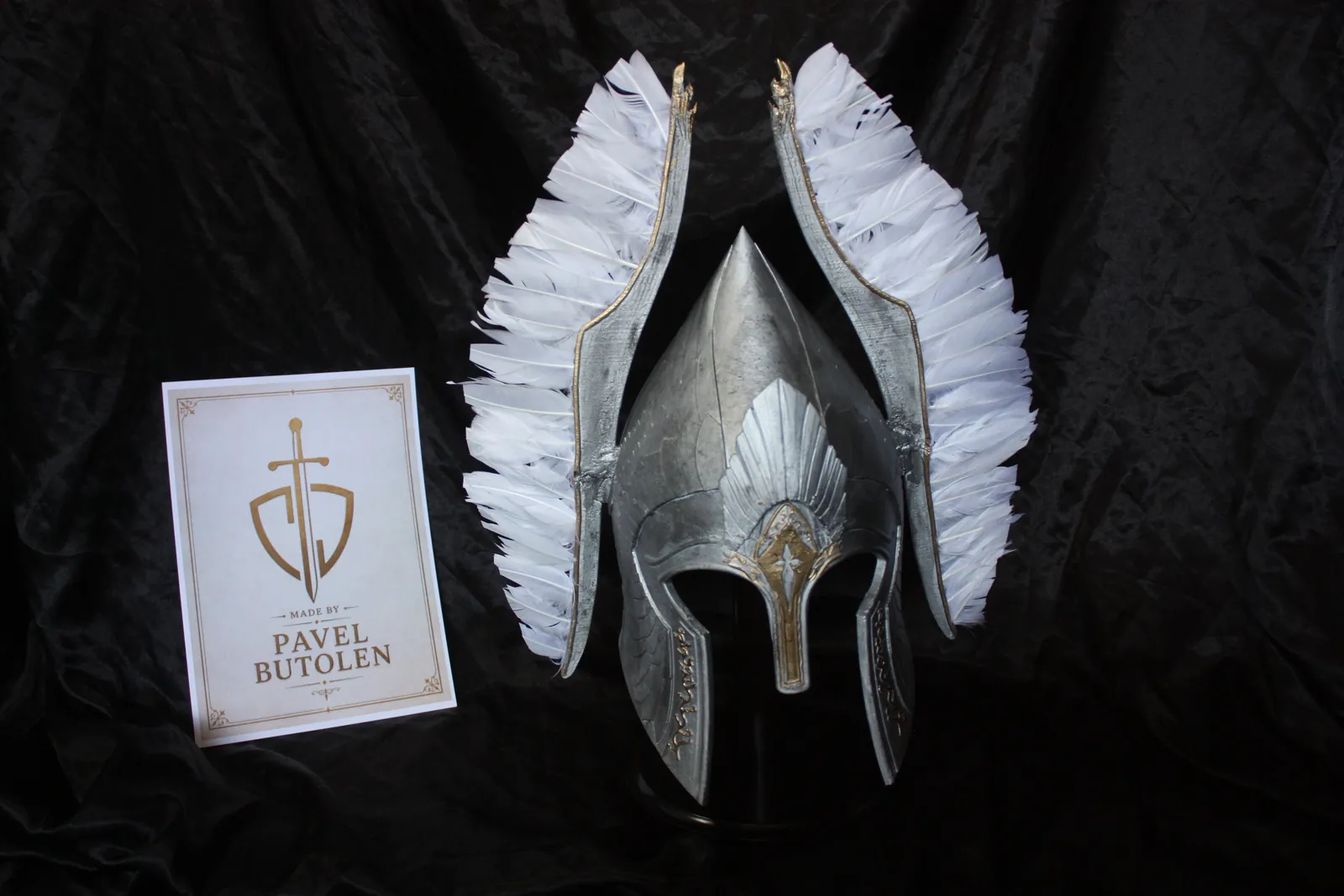Winged helmet with white feathers and a Pavel Butolen card, front view