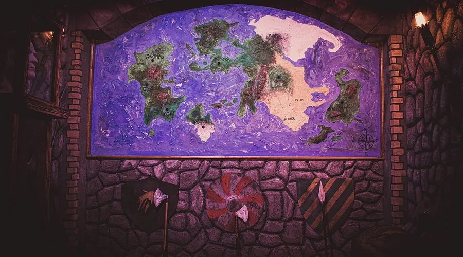 Wall with a handmade fantasy world map, shields and axes