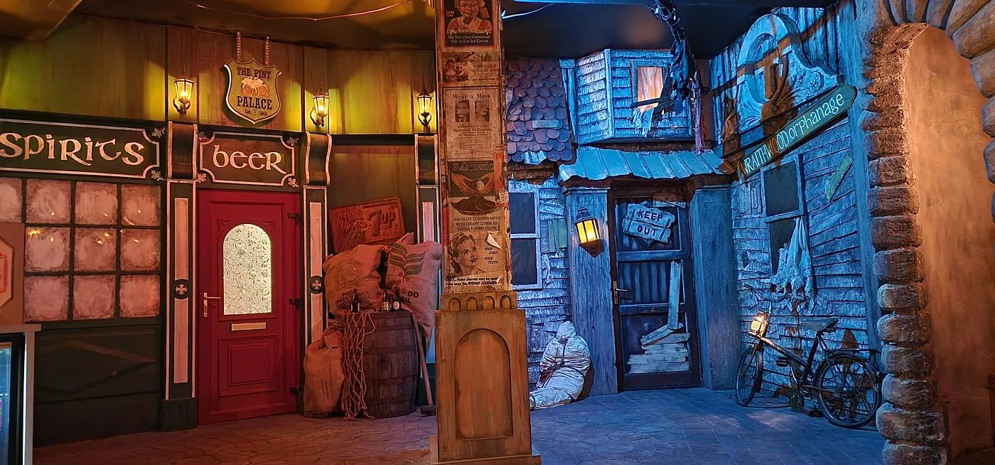 Themed street with a pub, posters and a run-down orphanage